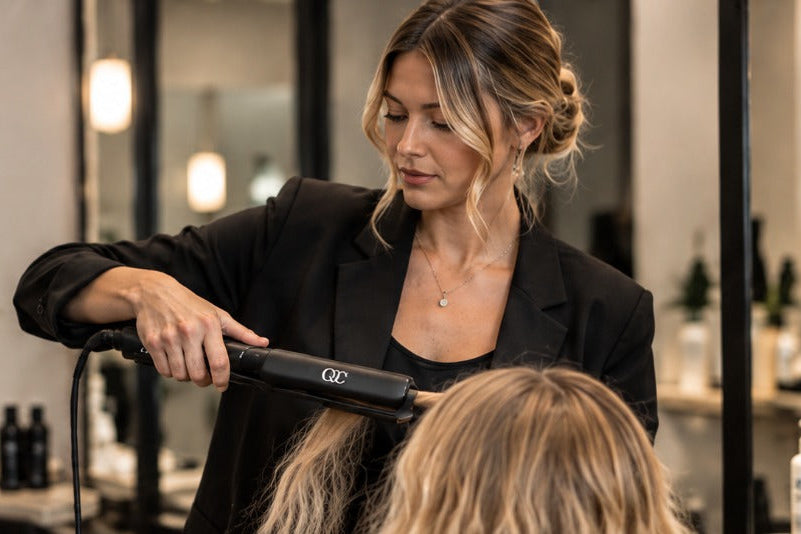 Stylist using a QC tool on a client in a salon